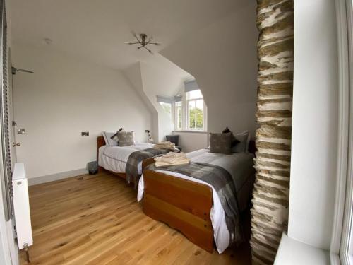 1 dormitorio con 2 camas y ventana en Manor House Hotel, en Thurso