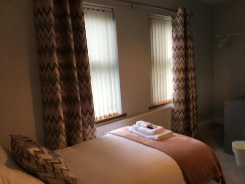 a bedroom with a bed with two towels on it at Binnian View Apartment in Kilkeel