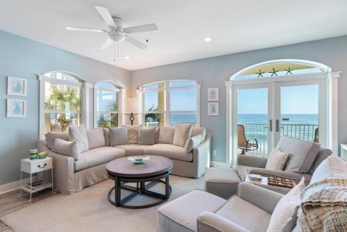 a living room with a couch and a table at The Villas at Santa Rosa Beach in Santa Rosa Beach