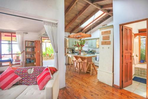 a living room and kitchen with a couch and a table at Casa Paxanax in Santa Cruz La Laguna