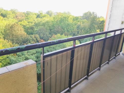 a balcony with a view of the forest at Apartament SIELANKA PARK in Łódź
