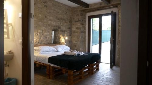 a bedroom with a bed with a teddy bear on it at Casa Giogano in San Leo