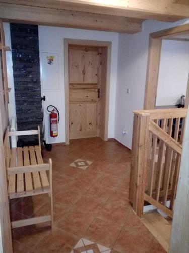 a room with a staircase and a fire extinguisher at Apartmány Roudnice in Jestrabi V Krkonosich