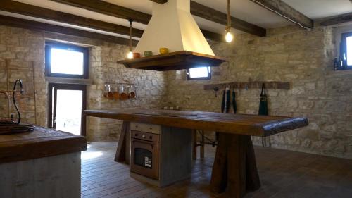 a kitchen with a large island in the middle at Casa Giogano in San Leo