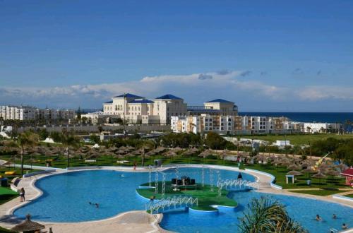 a large swimming pool in a resort with buildings in the background at Apartamento Marina Smir in Tetouan