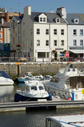 a group of boats are docked at a marina at Waterfront Apartments in Douglas