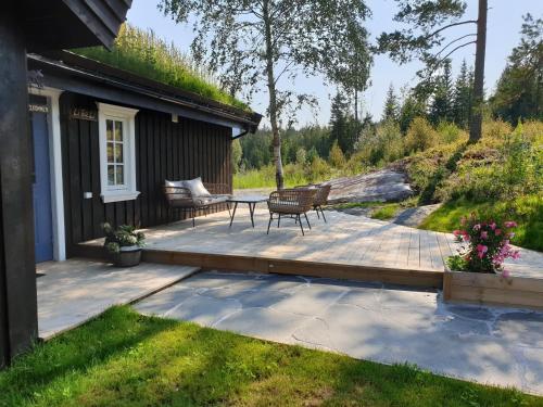 a patio with a table and a bench on a house at Libeli Panorama in Lona