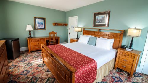 A bed or beds in a room at James Bay Inn Hotel, Suites & Cottage