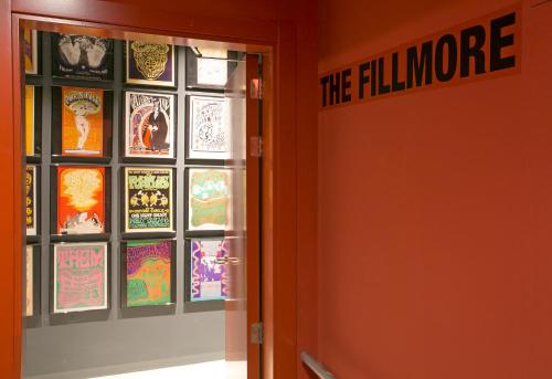 an orange door with the fillmore sign on the wall at Sant Jordi Hostels Rock Palace in Barcelona