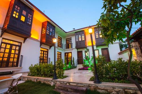 an exterior view of a house with many windows at Livia Garden Hotel in Selcuk
