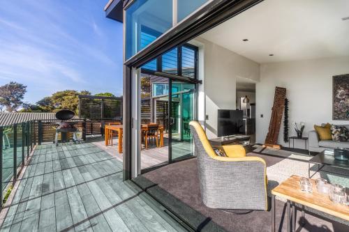 an open living room with sliding glass doors at Taonga with Sea Views by Waiheke Unlimited in Oneroa