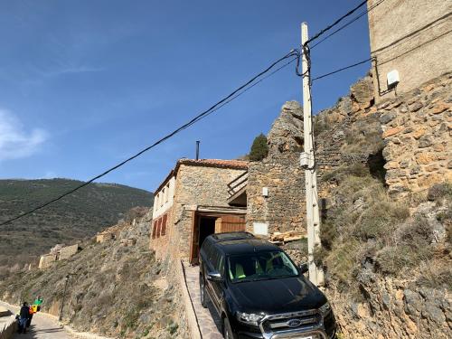a black car parked on the side of a mountain at Casa Purujosa in Purujosa