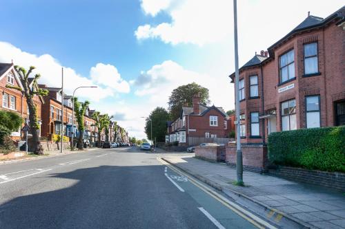 an empty street in a town with brick houses at Beautiful, Entire Luxurious One Bedroom Flat in Leicester