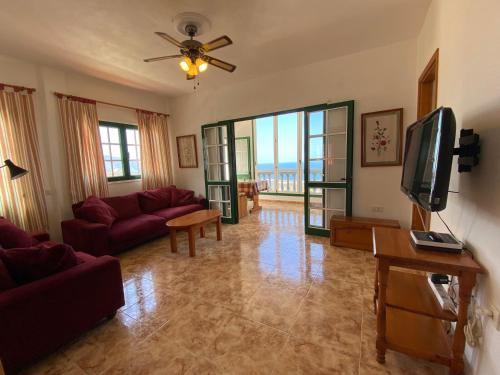 a living room with a couch and a tv at CASA PACO Y NINA in Frontera