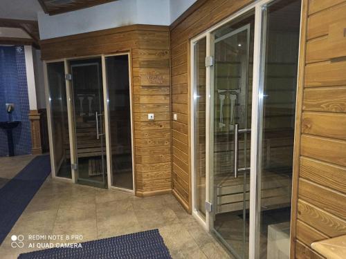 a row of glass cabinets in a room at Mountain view Private apartments in Pirin Golf and SPA resort in Razlog