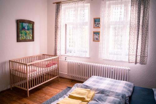 a baby bedroom with a crib and a window at U Mushera in Vrchlabí