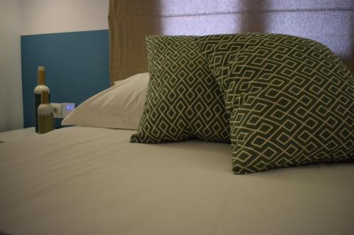 a bed with two pillows on top of it at Meltemi in Skiathos Town