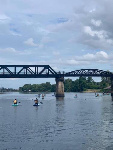a group of people in the water under a bridge at Felix River Kwai Resort - SHA Plus,Certified in Kanchanaburi