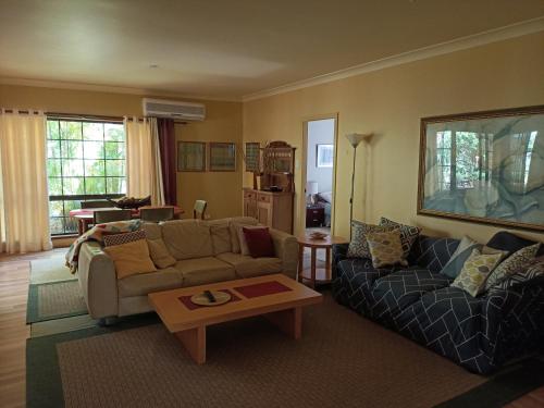a living room with a couch and a coffee table at Charming country house close to Grafton in Waterview Heights