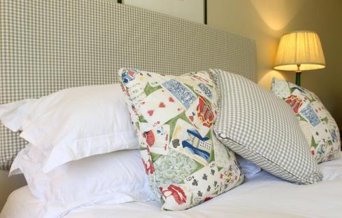 a bed with two pillows on top of it at Aylworth Manor in Naunton
