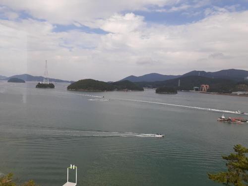 a boat in a large body of water at Tongyeong Bridge Hotel in Tongyeong