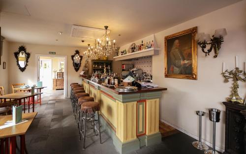 a bar in a restaurant with tables and chairs at Hotel Hacienda de Abajo-Adults Only-Lujo in Tazacorte