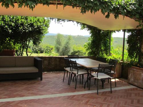 a patio with a table and chairs and a couch at Podere La Casa in Villa dʼArceno