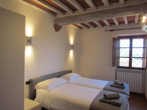 a bedroom with two beds and a window at Podere La Casa in Villa dʼArceno