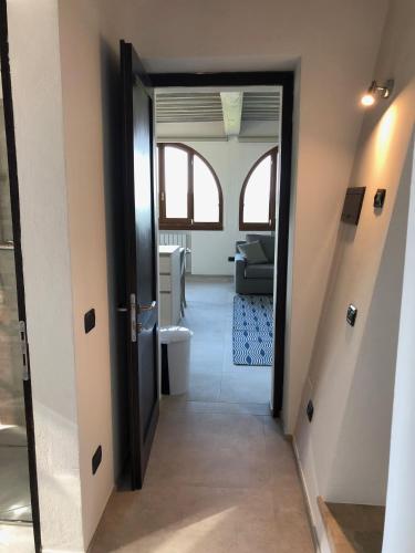 a hallway with a door leading into a room at Podere La Casa in Villa dʼArceno