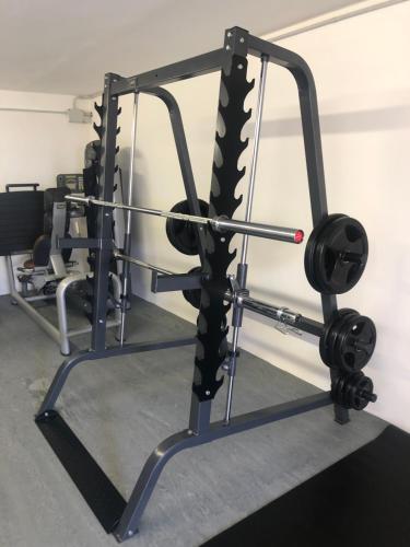 a gym with a squat rack with weights at Podere La Casa in Villa dʼArceno