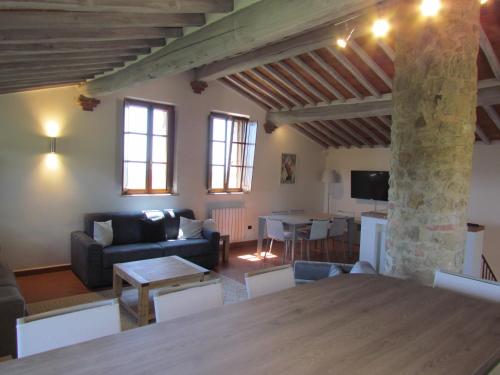 a living room with a couch and a table at Podere La Casa in Villa dʼArceno