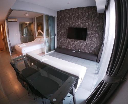 a view of a room with a bed and a television at BoonRumpa Accommodation in Bangkok