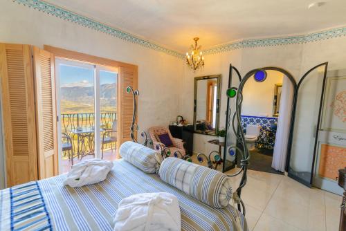 a bedroom with a bed and a view of a balcony at Las Orquideas Hotel Spain in Los Romanes