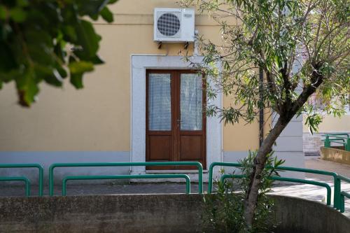 a building with green benches in front of a door at Hotel Don Giovanni in Ururi
