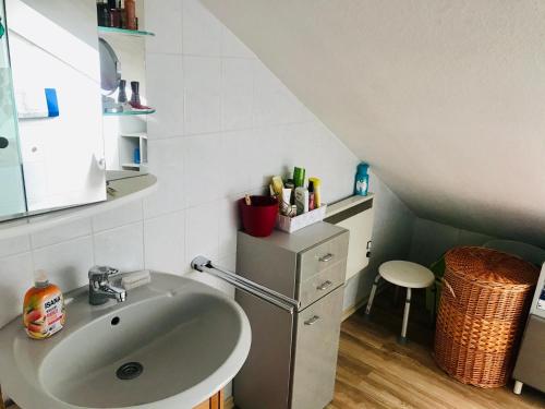 a bathroom with a sink and a counter with a stool at Apartment Liam in Rheinstetten