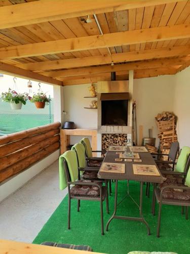 a dining room with a table and chairs and a fireplace at House Hanka, High Tatras in Stará Lesná