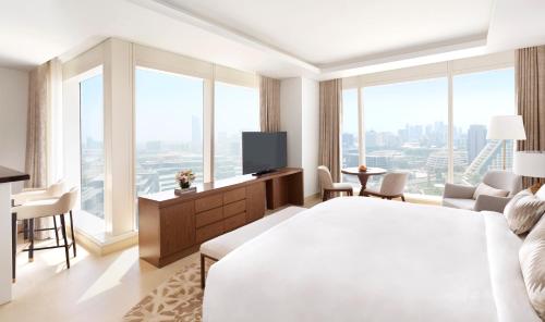 a hotel room with a bed and a television at Sofitel Dubai The Obelisk in Dubai