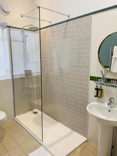 a bathroom with a shower and a sink at Embankment Hotel in Bedford