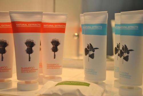 a group of four sunscreen bottles sitting on a counter at Legacy Preston International Hotel in Preston