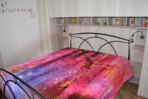 una camera con un letto con una coperta colorata di IL VECCHIO ULIVO a Cutrofiano