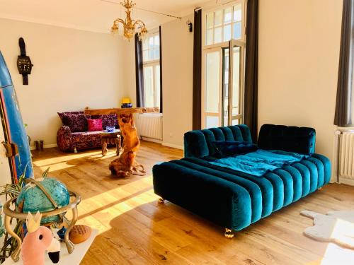 a living room with a couch and a dog in it at Blue Edition Cologne in Cologne