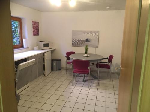 a kitchen with a table and chairs in a room at Apartment 4you in Eggolsheim