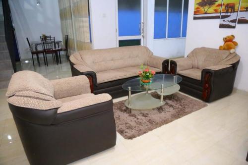 a living room with two couches and a glass table at White house in Nuwara Eliya