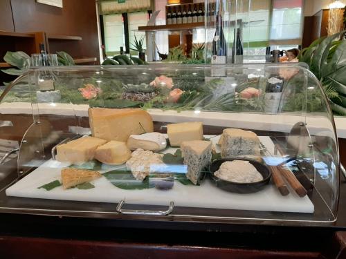 a tray of cheese and other foods on a table at Kyriad Hotel Nevers Centre in Nevers