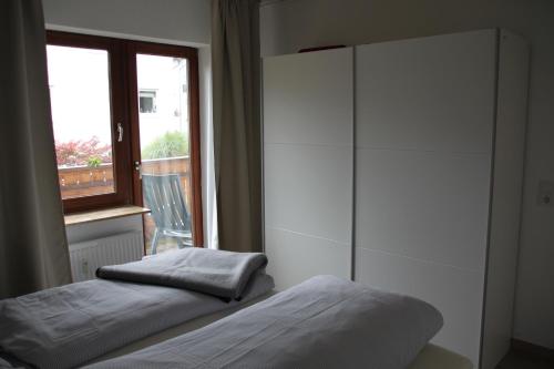 a bedroom with a bed and a large window at Haus Wanderlust in Willingen