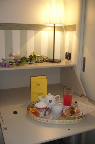 a tray of breakfast food on a table with a lamp at Appunti di Viaggio Room & Breakfast in San Giorgio di Piano