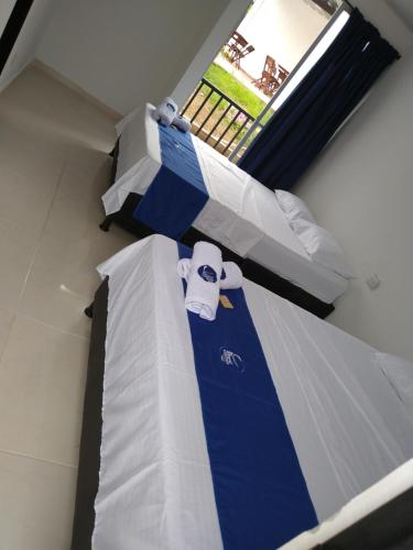 Uma cama ou camas num quarto em Cosmos Tatacoa Hotel