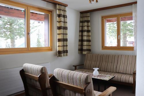 a living room with a couch and two chairs at Schönegg Hochparterre in Riederalp