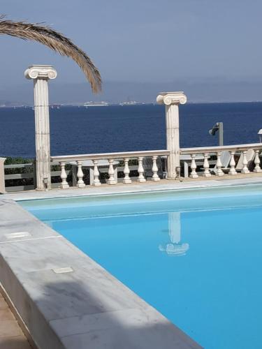 a swimming pool with the ocean in the background at Mistral in Souvala