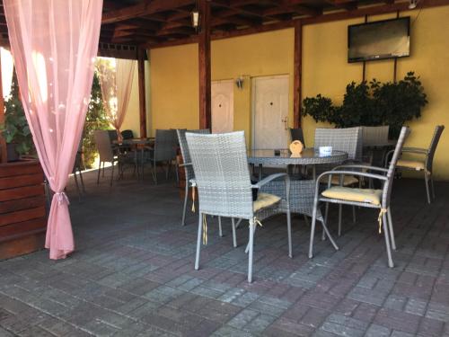 a patio with a table and chairs on a patio at Hostel Grof in Mrčajevci